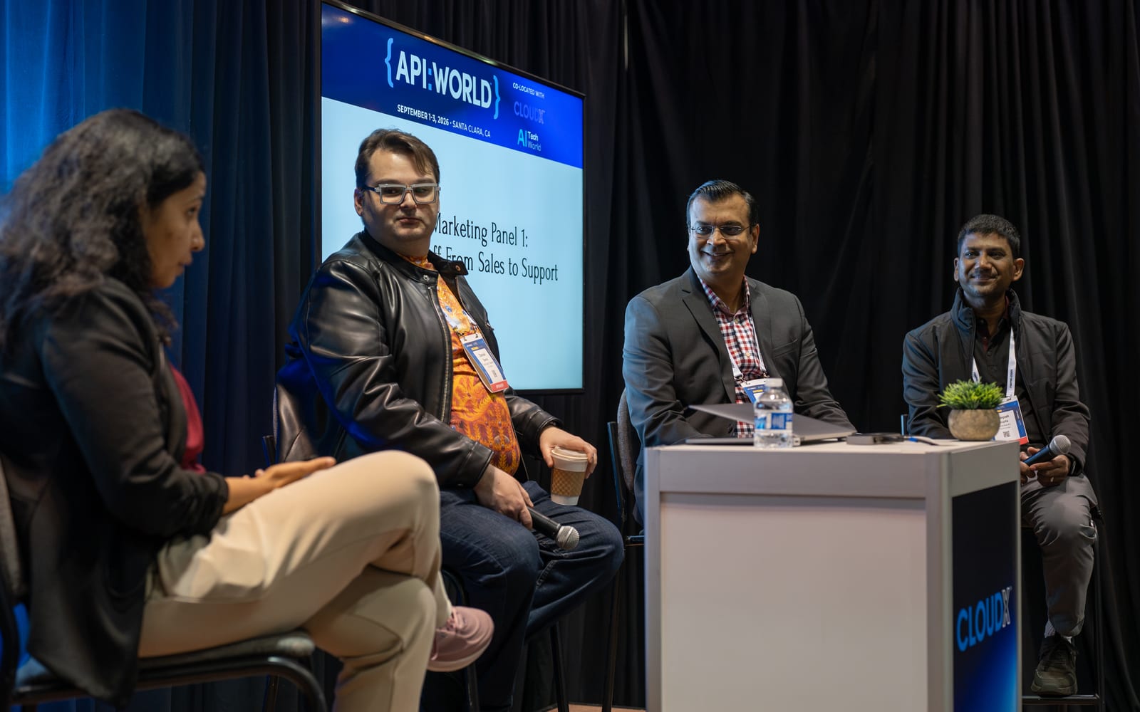 Panelists in discussion on stage, with the API World 2026 session title slide behind them