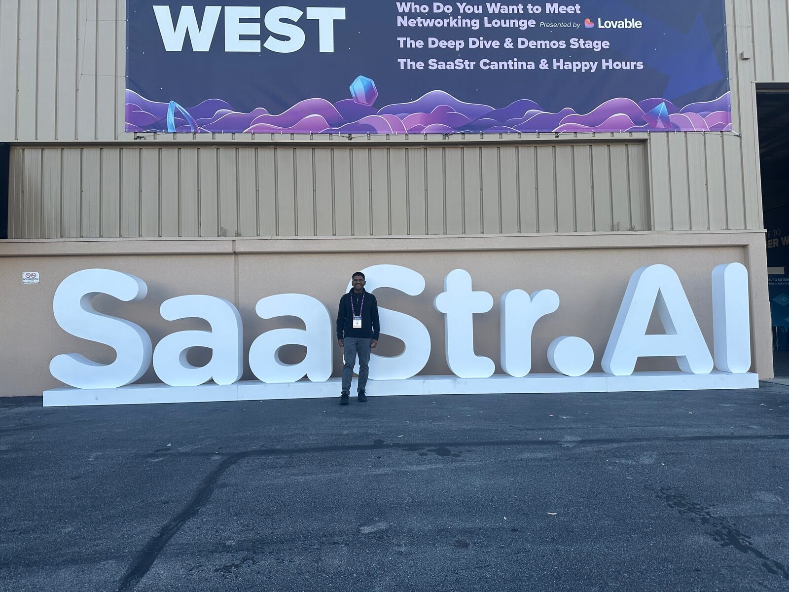 Deepak Gupta standing in front of the SaaStr.AI letter signage outside the West hall at the San Mateo County Event Center