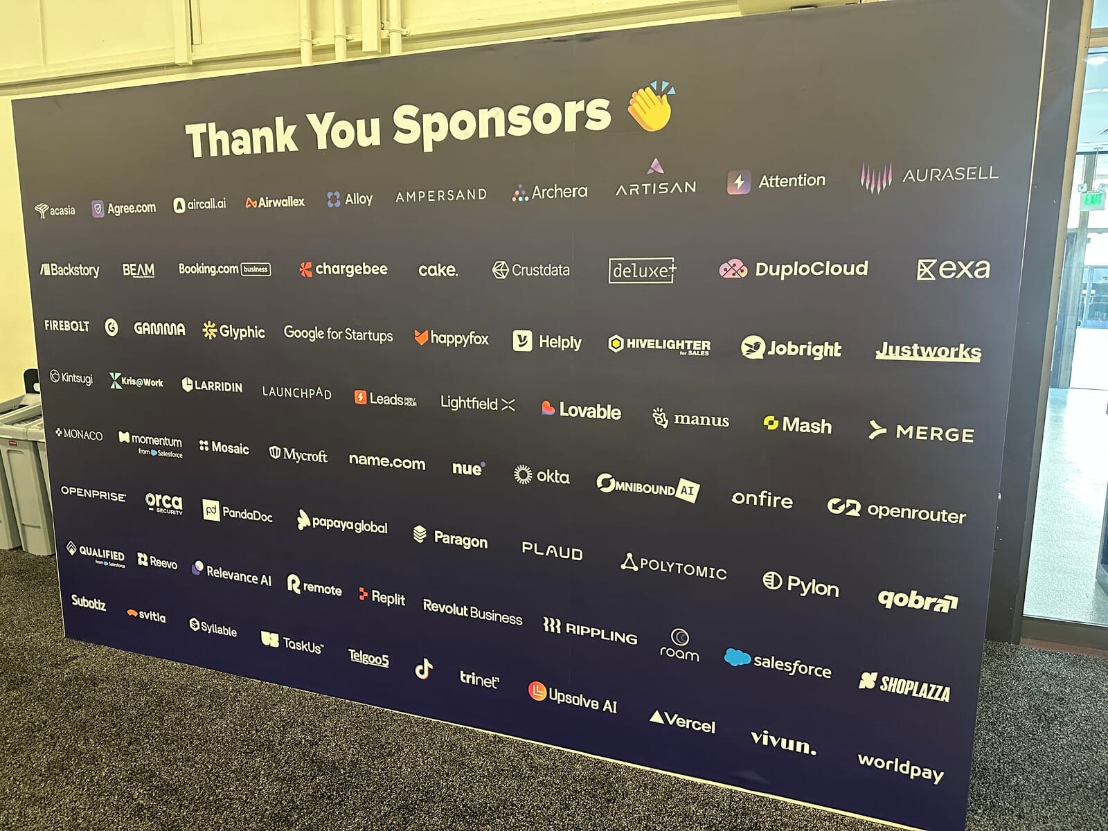 The SaaStr AI Annual 2026 sponsor wall listing roughly a hundred company logos